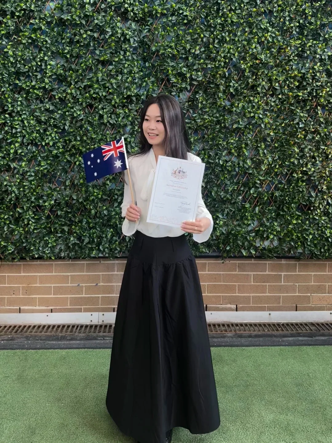 Woman with certificate and Australian flag