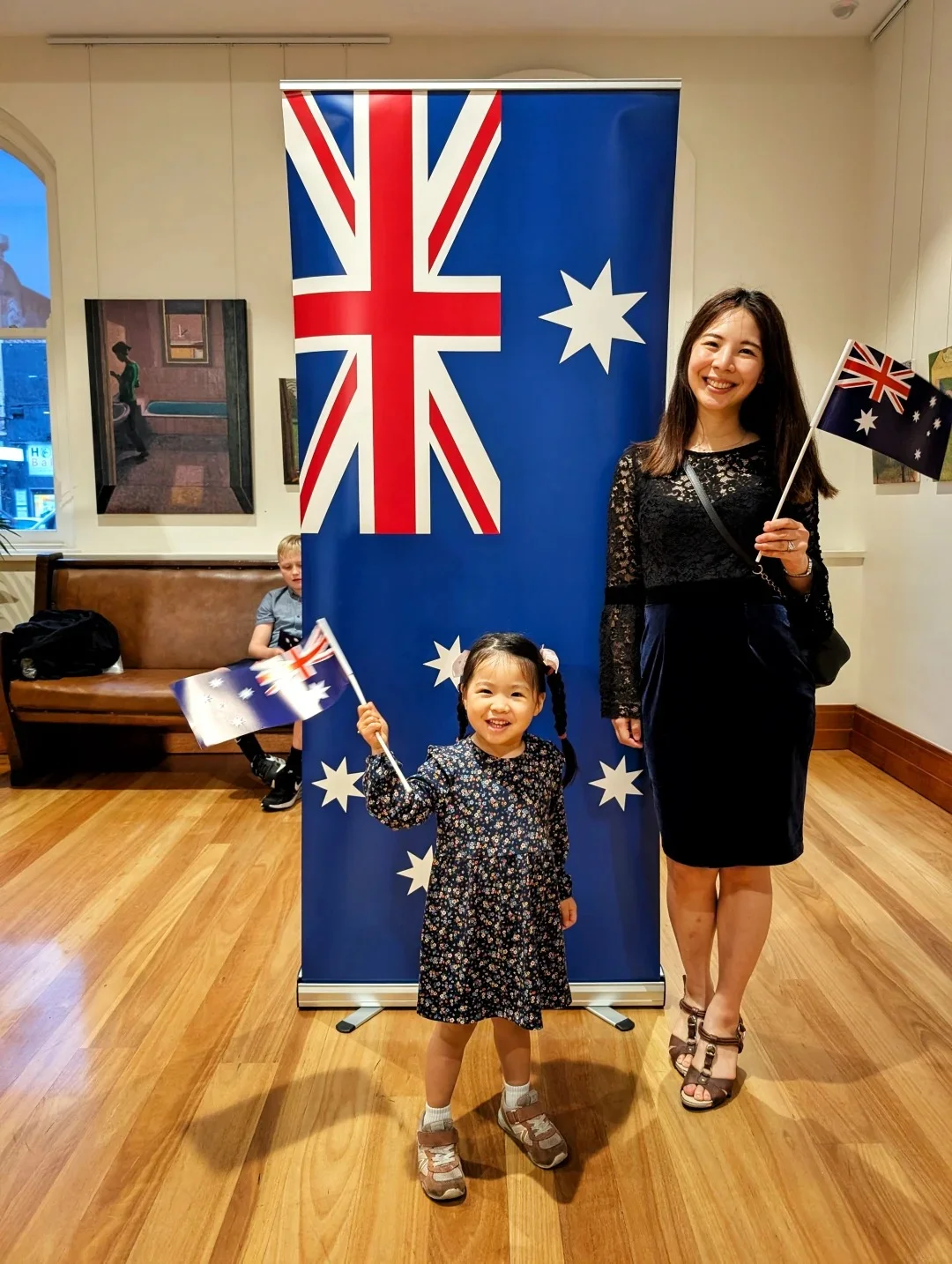 Woman holding Australian citizenship certificate